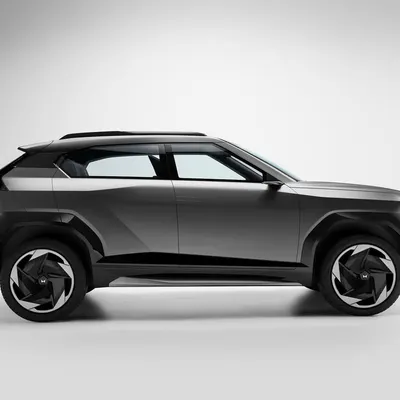 A full profile shot of the Mahindra Vision concept car. This minimalist composition against a clean background emphasizes the vehicle's futuristic silhouette and design language.