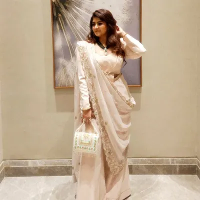 A full view of the powder peach powersuit with a zardozi dupatta. This Indo-Western ensemble is perfect for weddings or festive events, combining the structure of a suit with the grace of Indian embroidery.