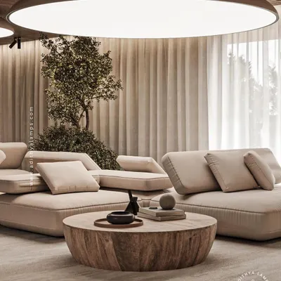 This living room features a large, circular stretch fabric ceiling light that mimics a natural skylight. It provides soft, even, and glare-free illumination that fills the entire space with a bright and airy feel.