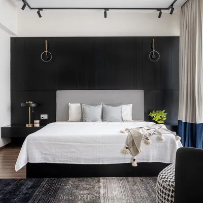 Go bold or go home. We absolutely love how this master bedroom turned out, with a dramatic black paneled wall creating a sophisticated and moody backdrop for the soft, light-colored bed and furnishings.