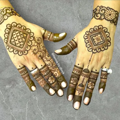 This design features a unique square-shaped mandala on the back of the hands. It's a modern twist on the classic circular pattern, perfect for someone looking for something different.