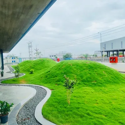 For this large commercial property, we blended modern architecture with natural forms. We created large, sculpted grass mounds and a winding pebble walkway to create a unique and memorable landscape that is both beautiful and durable.