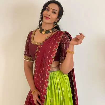 This lime green and maroon half saree is one of my most loved designs. The contrast is so eye-catching, and the hand-embroidered blouse adds a touch of elegance. It’s a perfect outfit for any festive occasion.