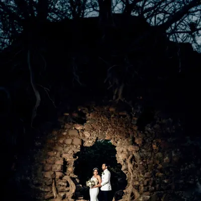 A dramatic, low-light portrait of the couple in a stone ruin. I used off-camera flash to illuminate them, creating a magical and mysterious image against the night sky.