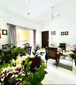 This wide shot showcases the spacious, high-ceilinged living and dining area. It's a versatile space designed for comfort, whether you're lounging on the couch or sitting down for a meal.