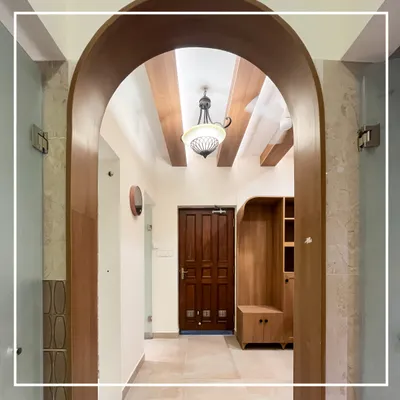 An elegant wooden archway frames the entrance to the ladies' section, immediately establishing a sense of classic design. This view highlights the custom shoe rack and storage unit, blending functionality with the overall heritage aesthetic.