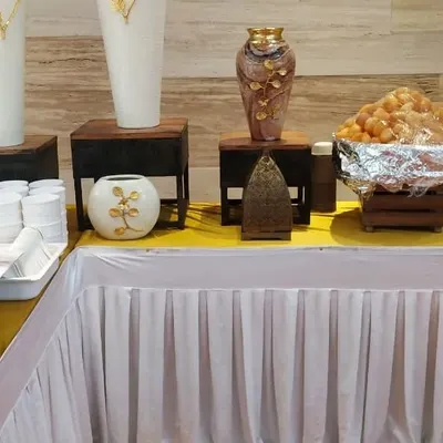 This photo shows a dessert station from one of my catered events. A large tray of fresh Gulab Jamun is ready to be served alongside elegant decor, making the dessert course a visual treat as well.