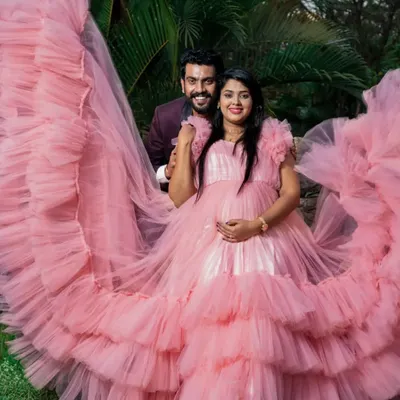 Celebrate your journey to motherhood with our special collection of maternity photoshoot gowns. This dramatic pink ruffled gown is designed for comfort and style, ensuring you get those breathtaking shots.