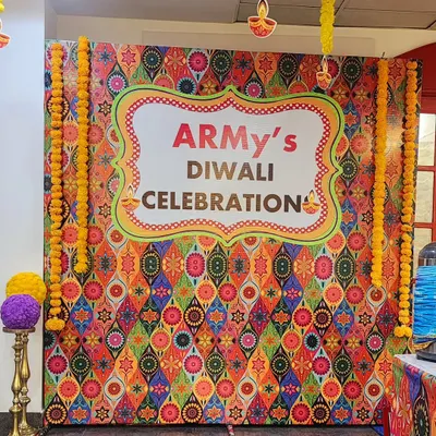This custom photo backdrop was the centerpiece for a corporate Diwali celebration. The design features a vibrant, multi-colored traditional pattern and was framed with beautiful marigold garlands to create a perfect spot for festive photos.