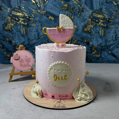 A beautiful "It's a Baby Girl" cake for a baby shower. This pink buttercream cake is topped with an intricate, handcrafted sugar pram.