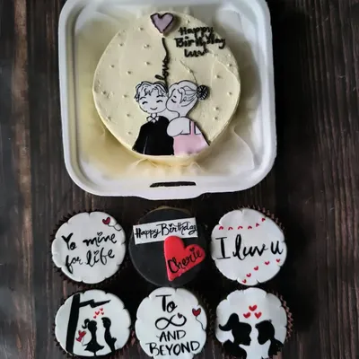 A romantic combo featuring a hand-painted bento cake of a couple's sweet moment, paired with cupcakes that continue the love story with messages and silhouettes.