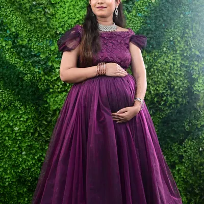 A beautiful mom-to-be glowing in our purple off-shoulder maternity gown. This style is very popular for both indoor and outdoor photoshoots.