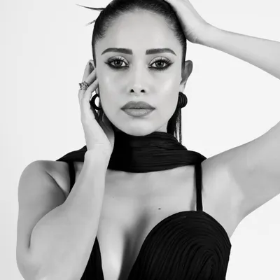 A stunning black and white close-up of Nushrratt Bharuccha. The high-contrast lighting and sharp focus on her eyes create a powerful and intimate portrait.