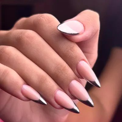 Sleek, sharp, and impossibly chic. This chrome-tipped French manicure on a long stiletto nail is the definition of modern elegance.