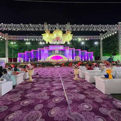 For large-scale sangeet nights and receptions, I provide full stage and lighting production. This setup features a massive overhead lighting truss, multiple custom chandeliers, and a multi-tiered stage to create an unforgettable concert-like atmosphere.