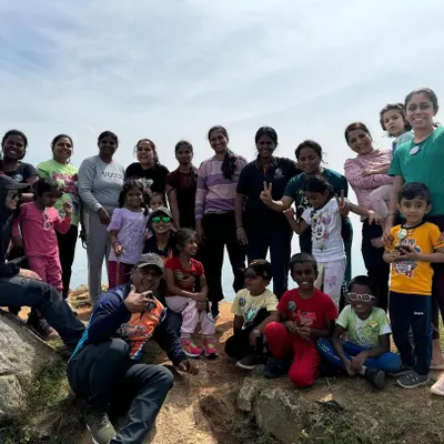 A large group of mothers and their children posing together on a mountaintop. Our 'Mom & Me' treks are a wonderful way for families to connect with nature and each other.