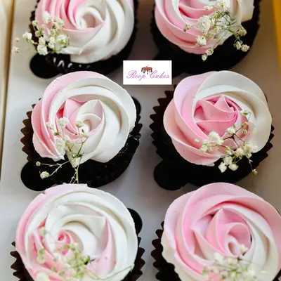 Perfect for a bridal shower, these cupcakes feature beautiful pink and white frosting swirled into a rose shape. A touch of baby's breath adds a simple, elegant finish to celebrate the bride-to-be.