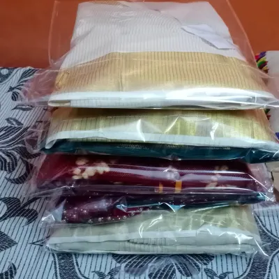 A stack of sarees, all pleated, finished, and packed for my clients. This is how your sarees will be delivered, ready to store or travel with.