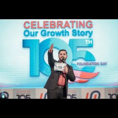 On stage, commanding the room during a corporate foundation day celebration. My focus is always on creating a dynamic atmosphere that celebrates the company's growth story.