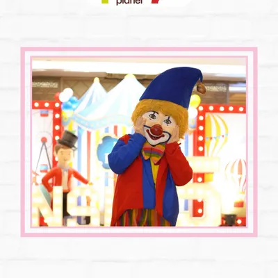 A friendly clown mascot at a circus-themed party, ready to entertain guests and bring smiles to everyone's faces.