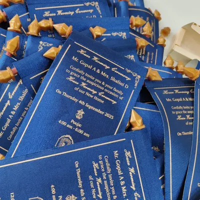 A pile of royal blue satin scroll invitations, each tied and ready to be sent out, showcasing a unique and memorable way to invite guests.