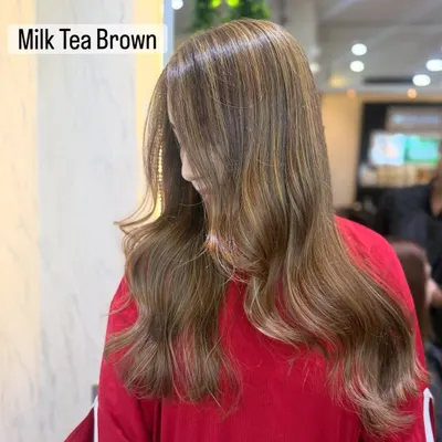 A beautiful example of a soft, illuminated bronde in a shade we call Milk Tea Brown. It's the perfect mix of brown and blonde.