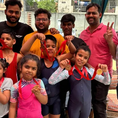 A proud moment with the team. Celebrating the hard-earned medals of our young gymnasts after a competition.