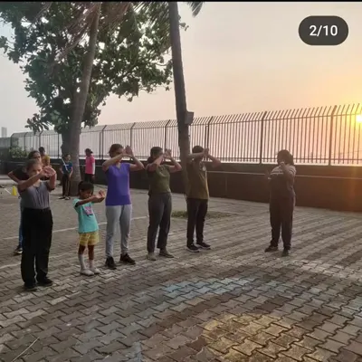 Every session begins with proper warm-ups and stance practice. Here, a group of students learns the correct body alignment before even picking up a bow, ensuring a solid foundation for safety and accuracy.
