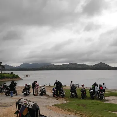 Our riders and their bikes parked by the serene Mydala Kare Lake during a breakfast ride. These rides are as much about the destination and the conversations as they are about the journey.