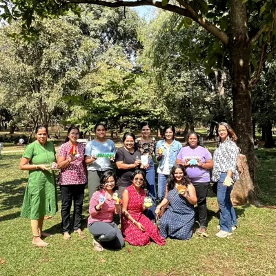 A happy group photo from our "Strokes and Stories" session in the park. Everyone proudly holding up their finished pieces is the best part of my day.