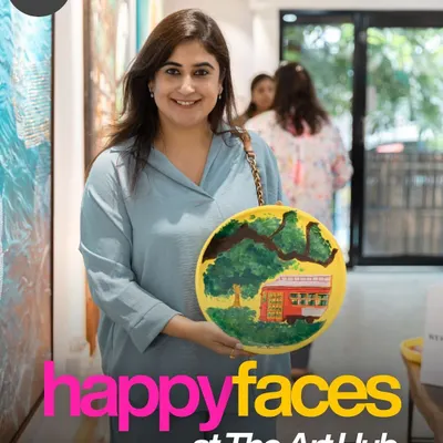 A happy participant proudly presents the vibrant plate she painted. Everyone leaves our workshops with a finished piece of art, a tangible reminder of their creative achievement and a fun day with their team.