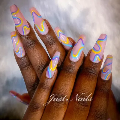 A true work of art on extra-long coffin nails. This design features a mesmerizing, multi-colored wavy pattern that showcases my passion for creating unique, custom looks.