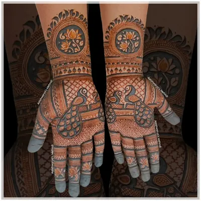A classic design featuring two peacocks on each palm, surrounded by a delicate net pattern. The wrists are adorned with a lotus mandala.