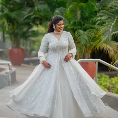 For the Sangeet, comfort is key for a night of dancing. We chose this gorgeous ivory jacket-style lehenga with intricate zardozi work. The flowing organza skirt is lightweight and perfect for twirling on the dance floor.