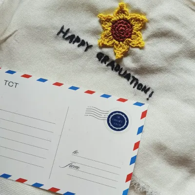 Add a personal message to your gift with our custom TCT postcards. This one is shown with a "Happy Graduation" note and a small crochet sunflower accent.