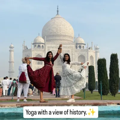Yoga with a view of history. Practicing Natarajasana (Dancer's Pose) with a friend at the timeless Taj Mahal, a symbol of love and balance.