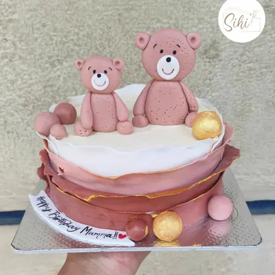 From a daughter to her mama bear. This sweet cake features two fondant teddy bears and a modern, layered chocolate wrap design in dusty rose tones.