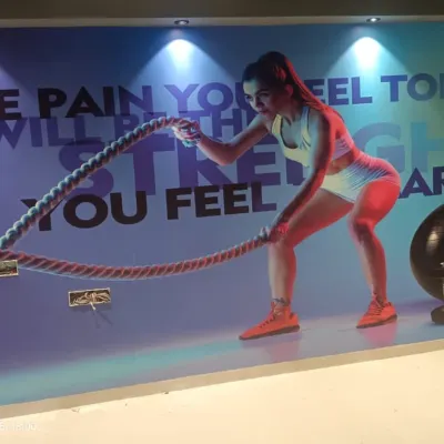 A high-energy fitness mural installed in a gym. The vibrant colors and motivational text are perfect for creating an inspiring workout environment.