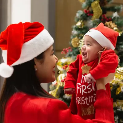 There is nothing more special than a baby's first Christmas. I love capturing the pure joy between a mother and her child, using the family's own festive tree as the perfect, personal backdrop for this unforgettable milestone.