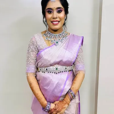 This bride wanted a modern yet elegant look for her semi-bridal event. We chose this sparkling American Diamond choker and matching oddiyanam (hip belt) to complement her beautiful lavender silk saree.