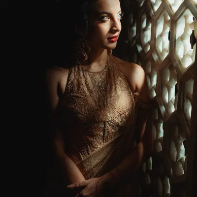 A vision in gold for her reception. Tessa was glowing with a bold red lip and golden shimmer on her eyes. This look is the perfect balance of radiance and grace, a glamorous end to the wedding festivities.