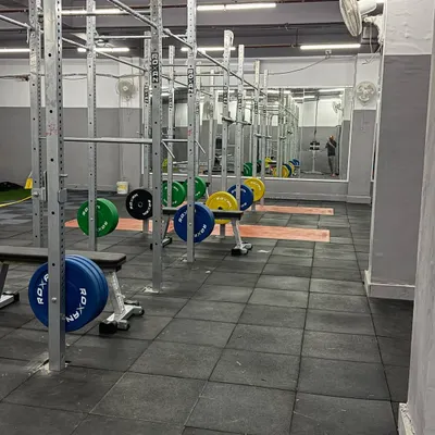A look at the power racks and lifting platforms in my gym. This setup is the heart of our strength program, allowing for safe and effective execution of essential compound lifts like squats, presses, and deadlifts.