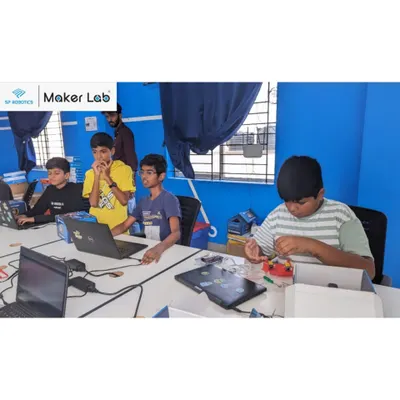 A typical day in our Maker Lab, where students are deeply engaged in building their projects. Here, they are working with our robotics kits, learning through hands-on tinkering and problem-solving.