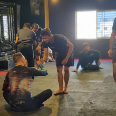A moment of respect and connection as a student shakes hands with visiting Professor Bernd Roeske after a roll.