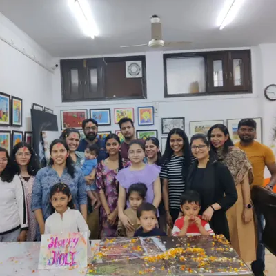 A group photo of our students and instructors celebrating Holi at the studio. We believe in fostering a joyful community alongside artistic growth.