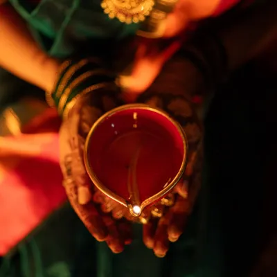 The warm glow of a diya held in hands adorned with mehendi. This shot was from a Diwali shoot, but it represents the kind of detailed, atmospheric photos I love to take. These small elements are a big part of our festive and wedding traditions.