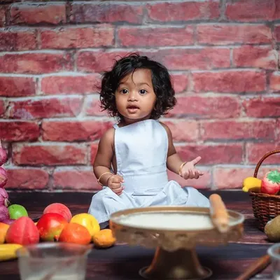Here is our 'Little Chef' in action. This themed milestone shoot is perfect for babies who are sitting up. The set includes a brick backdrop, a mini kitchen setup, and even real flour for a fun, messy experience.