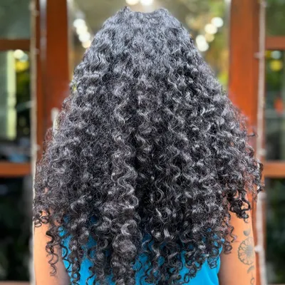 This client was ready for the big chop! We went from long, weighed-down hair to a short, voluminous style that lets her tight curls spring to life.