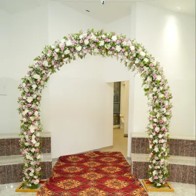 A beautiful floral arch designed for a house warming ceremony, creating a welcoming entrance for guests.