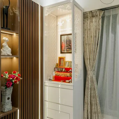 A beautifully crafted mandir designed to be the spiritual heart of the home. This unit features intricate jali work on the sides, warm backlighting, and drawers for storing pooja essentials.
